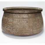 A large Islamic tinned copper bowl, inscribed in Kufic script, 38cm diameter***CONDITION REPORT***