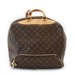 A Louis Vuitton Evasion travel bag features a monogram canvas body, rolled Vachetta leather handles,