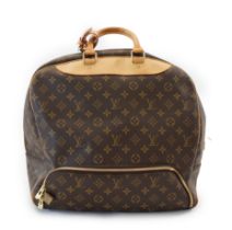 A Louis Vuitton Evasion travel bag features a monogram canvas body, rolled Vachetta leather handles,