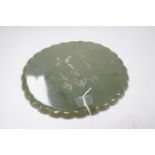 A Mughal style oval celadon jade dish, with petal lobed rim the underside carved with leaves, wood