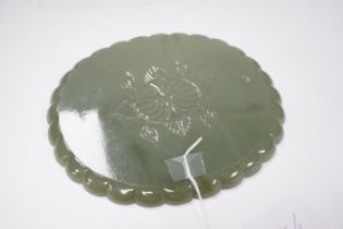 A Mughal style oval celadon jade dish, with petal lobed rim the underside carved with leaves, wood