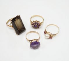 Two modern 9ct gold and gem set dress rings and two other yellow metal and gem set dress rings,