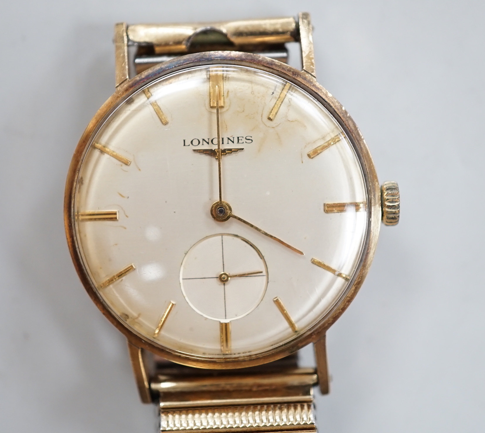 A gentleman's 9ct. gold Longines manual wind wrist watch, with engraved inscription, on an