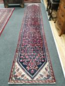 A Caucasian blue ground runner, approx. 400 x 71cm***CONDITION REPORT***PLEASE NOTE:- Prospective