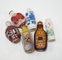 Four Chinese overlaid glass snuff bottles and two Chinese porcelain snuff bottles, three with