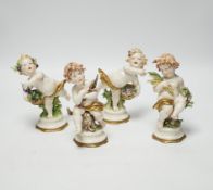 A set of four Naples porcelain figures of cherubs, 15cm tall