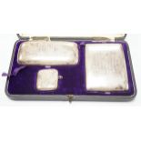 A George V cased silver three piece smoker's set, comprising a cigar, cigarette and vesta case,