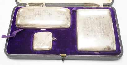 A George V cased silver three piece smoker's set, comprising a cigar, cigarette and vesta case,
