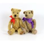 A plush covered bear with purple ribbon, 30cm and a plush covered bear with tartan ribbon, 36cm (2)