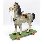 A push along vintage toy horse with pull-string soundbox, 47cm high