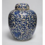 A large 19th century Chinese blue and white crackle-glaze ‘lotus’ jar and cover 32cm