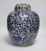 A large 19th century Chinese blue and white crackle-glaze ‘lotus’ jar and cover 32cm