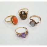 Two modern 10k and gem set rings, including amethyst and diamond chip and two yellow metal and gem