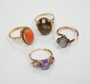 Two modern 10k and gem set rings, including amethyst and diamond chip and two yellow metal and gem