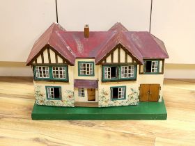 A 1930's Tri-ang doll's house with opening front and a small quantity of furniture