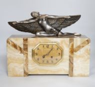 An Art Deco marble mantel clock with a metal winged woman, with French pendulum movement striking on