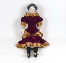 A glazed shoulder china head doll, c.1870, 53cm, some rubbing of hair, cloth body, original dress in