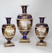 A three piece garniture of Derby vases, c.1810, each painted with titled views ‘In Wales’ and ‘