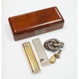 Two Dunhill lighters, largest 72mm, a yellow metal mounted scarab pendant, a gold plated and white