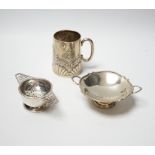 An Edwardian embossed silver christening mug, Birmingham, 1903, height 8cm, together with a silver