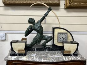 A French Art Deco bronzed spelter archer and cream and black marble mantel clock garniture, 50cm