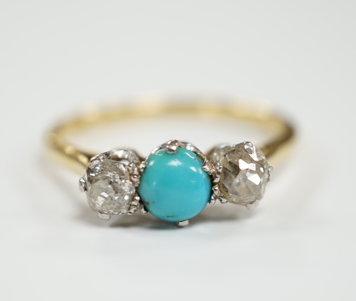 An 18ct, single stone turquoise and two stone diamond set ring, size O, gross weight 2.9 grams.