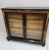 A late Victorian amboyna banded ebonised side cabinet, width 115cm, depth 32cm, height 103cm