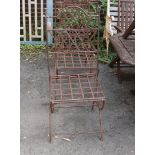 A set of four wrought iron folding garden chairs with seat pads, height 104cm