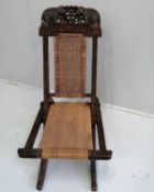 An Anglo Indian caned carved hardwood folding chair, height 88cm
