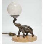 An Art Deco spelter elephant table lamp with glass globe shade, 27cm high