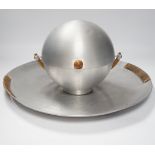 A Russell Wright spun aluminium ‘bun’ warmer and tray with woven handles, largest 45cm in diameter