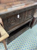 A 17th century and later carved oak potboard cupboard on stand, width 123cm, depth 43cm, height
