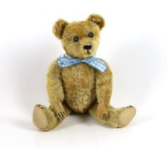 An early German bear, c.1920, with set in ears, black button eyes, 35cm, replaced paw pads,