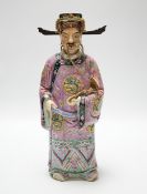 An early 20th century Chinese enamelled porcelain figure of an immortal, 31.5 cm high