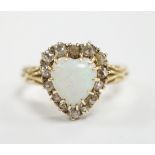 A yellow metal, white opal and diamond set heart shaped cluster ring, size N, gross weight 3.7