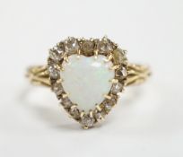 A yellow metal, white opal and diamond set heart shaped cluster ring, size N, gross weight 3.7