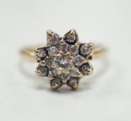 A modern 9ct gold and diamond cluster ring, size K/L, gross weight 3.1 grams.