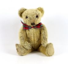 A 1930's Merrythought bear, with label, 44cm, old repair to foot, some hair loss