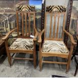 A pair of early 20th century Arts and Crafts oak elbow chairs, width 61cm, depth 55cm, height 118cm