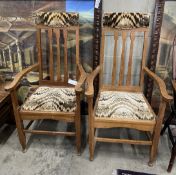 A pair of early 20th century Arts and Crafts oak elbow chairs, width 61cm, depth 55cm, height 118cm