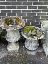 A pair of reconstituted stone circular campana garden urns, one lacks base, larger diameter 44cm,