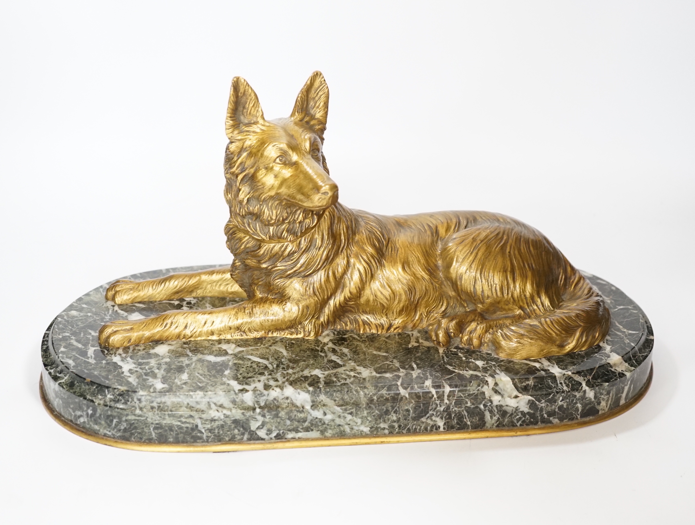 A recumbent dog gilt bronze on marble plinth, style of Chiparus, 40cm long