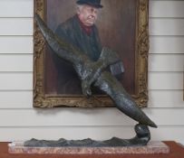 A large French bronze model of a bird in flight, mounted on rouge marble signed Garreau, 69cm high