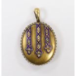 A Victorian engraved yellow metal, enamel and seed pearl set oval locket, overall 45mm, gross weight