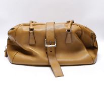 A Prada tan leather zipped handbag with leather strap and Prada lock and interior lining