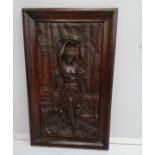 A rectangular carved wood relief plaque depicting a female dancer with tambourine, width 37cm,