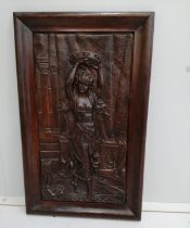 A rectangular carved wood relief plaque depicting a female dancer with tambourine, width 37cm,