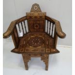 A Moorish inlaid hardwood elbow chair, width 60cm, depth 44cm, height 90cm