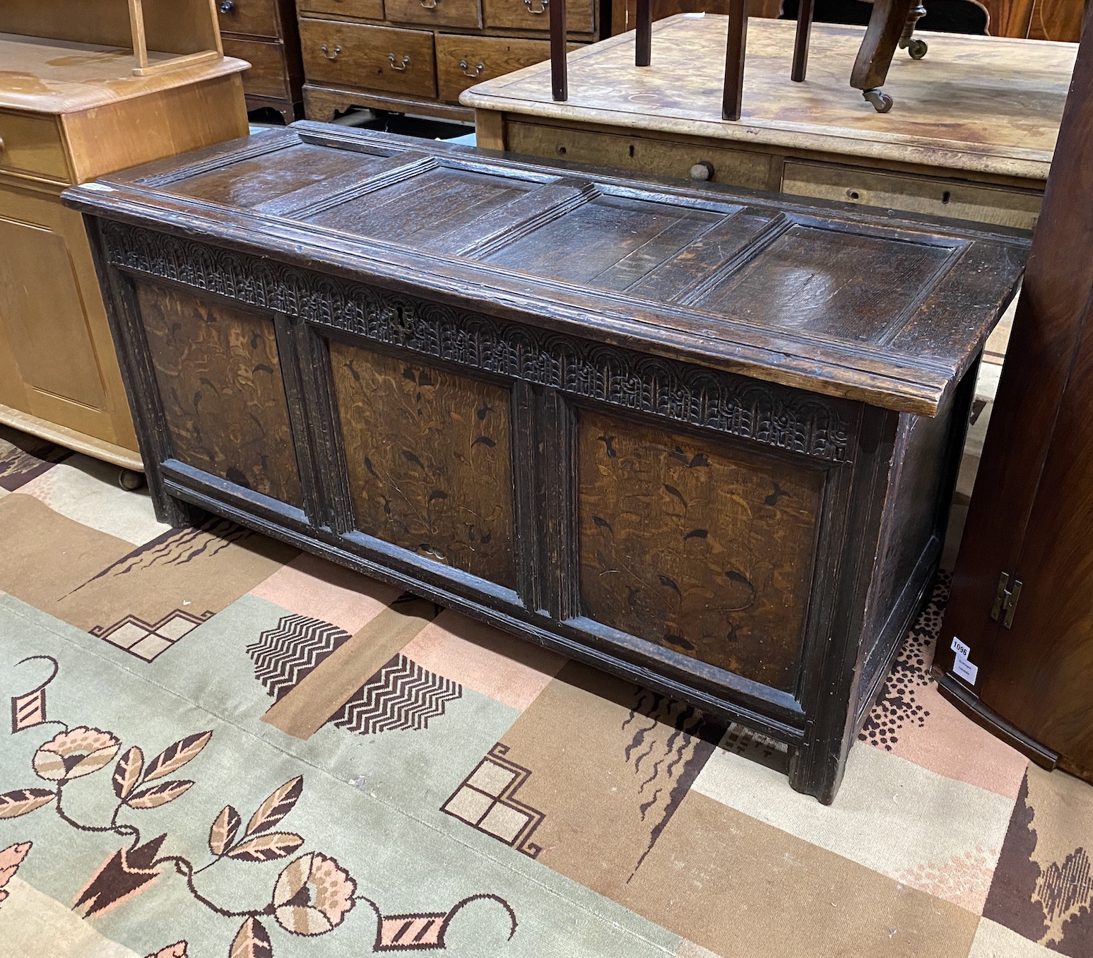 A 17th century inlaid oak panelled coffer, width 139cm, depth 56cm, height 64cm