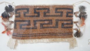 A framed textile possibly American Indian